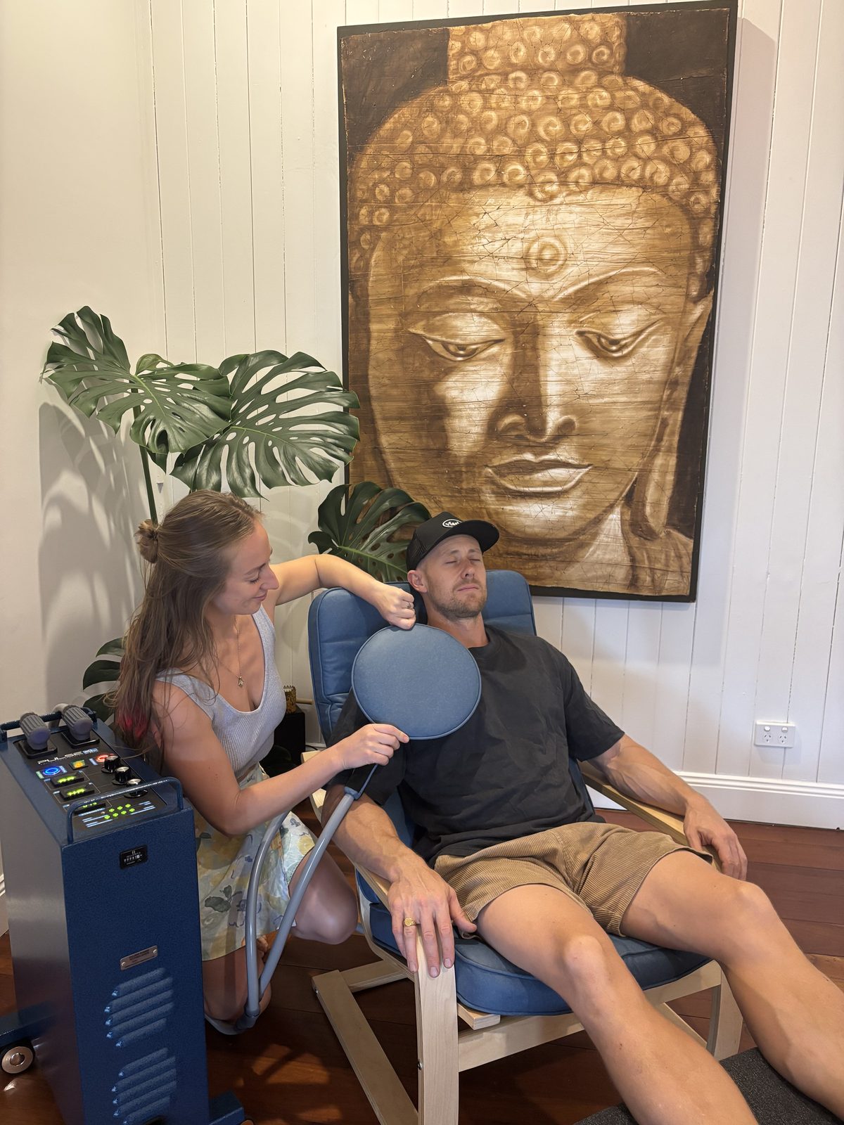 Client deeply relaxed in the Nu Wave chair mid-session